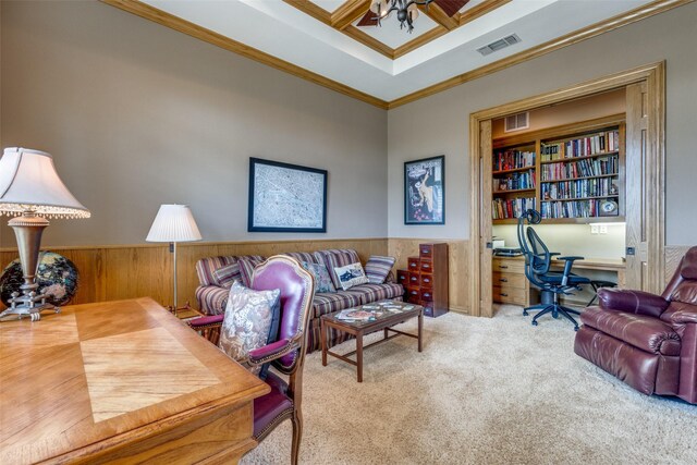 carpeted office featuring ornamental molding, ceiling fan, and wooden walls