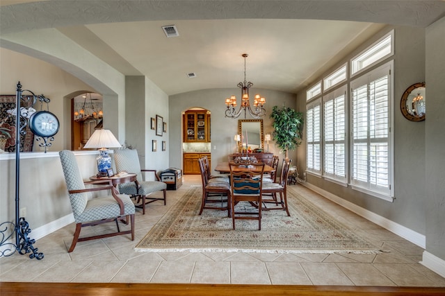 dining room with lofted ceiling, a chandelier, and light hardwood / wood-style floors