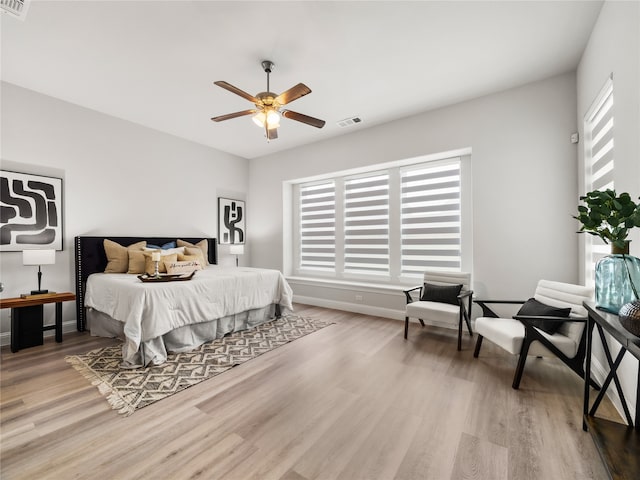 bedroom with ceiling fan and wood-type flooring