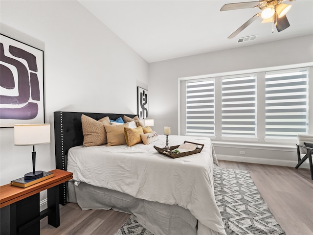 bedroom featuring ceiling fan, vaulted ceiling, and light hardwood / wood-style floors