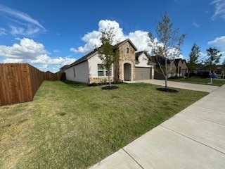 view of front of home featuring a garage and a front lawn