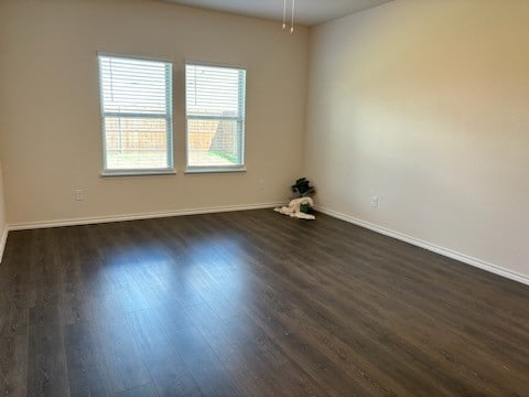 unfurnished room featuring dark hardwood / wood-style flooring and ceiling fan