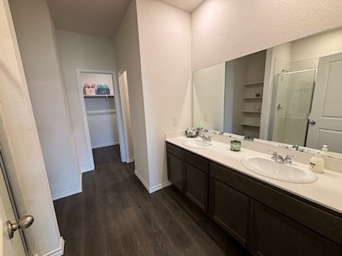 bathroom featuring vanity, hardwood / wood-style flooring, and a shower with shower door