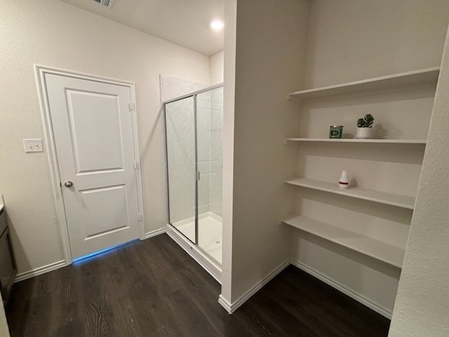 bathroom featuring vanity, hardwood / wood-style floors, and a shower with shower door