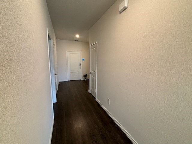 hallway featuring dark hardwood / wood-style floors