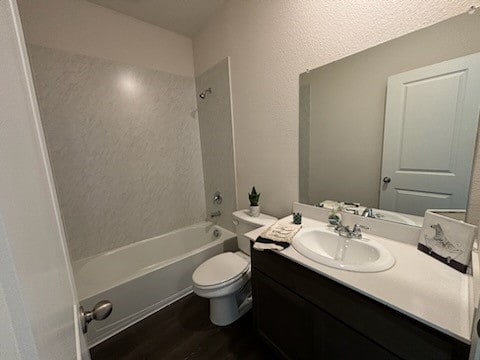 full bathroom with hardwood / wood-style floors, vanity, toilet, and shower / bathtub combination