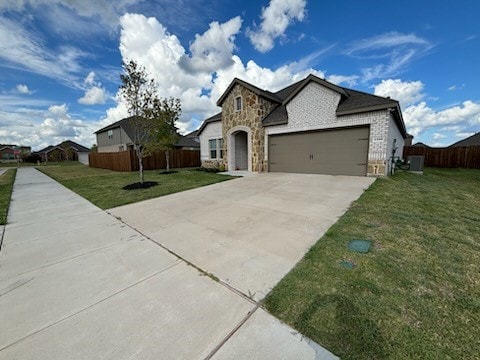 view of front of house featuring a garage and a front yard