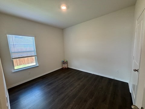 spare room with dark hardwood / wood-style flooring