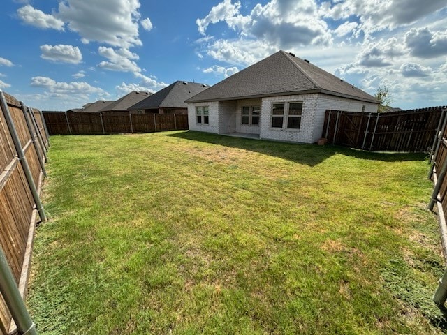 rear view of house featuring a lawn