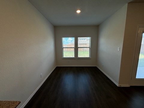 unfurnished room with dark hardwood / wood-style floors