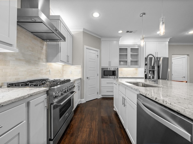 kitchen featuring ornamental molding, stainless steel appliances, dark hardwood / wood-style flooring, sink, and wall chimney range hood