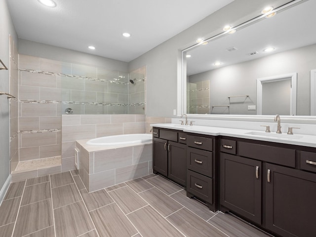 bathroom with vanity and independent shower and bath