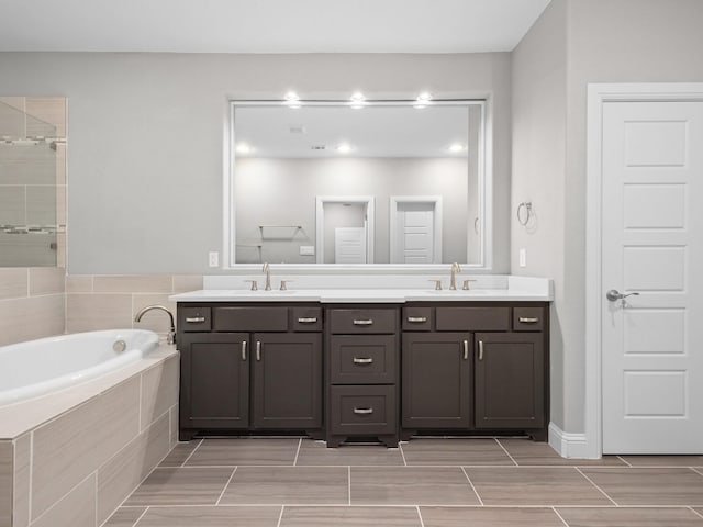 bathroom with vanity and shower with separate bathtub