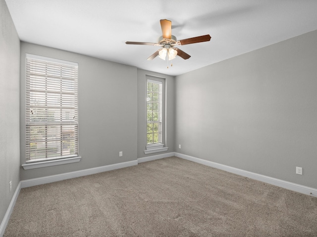 empty room featuring ceiling fan and carpet floors