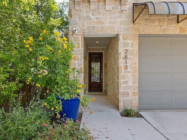 doorway to property featuring a garage