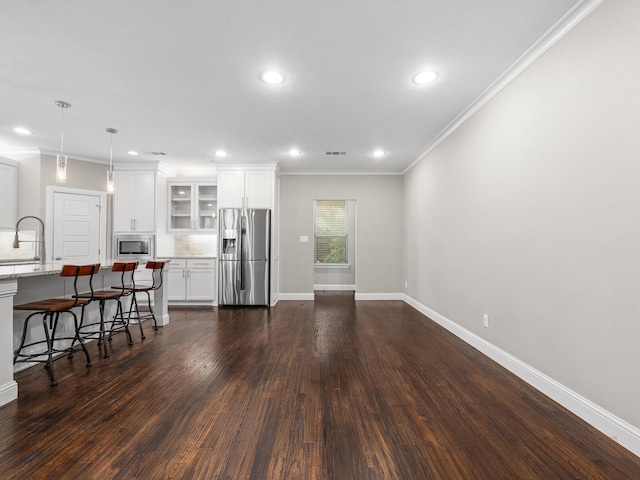 living room featuring ornamental molding, sink, and dark hardwood / wood-style floors