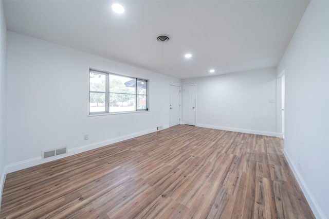 unfurnished room with hardwood / wood-style floors