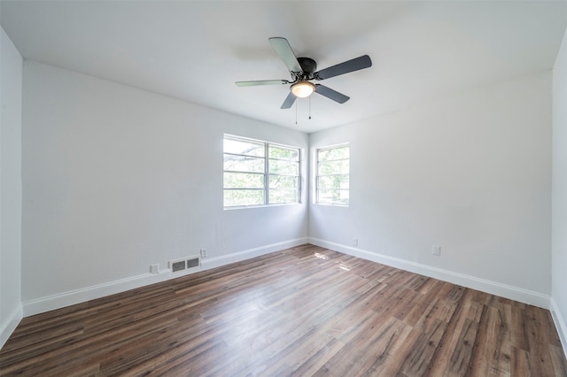 spare room featuring dark wood-type flooring and ceiling fan