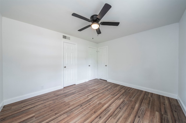 interior space with ceiling fan and dark hardwood / wood-style floors