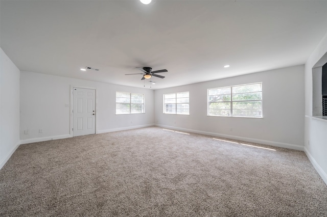 carpeted empty room featuring ceiling fan