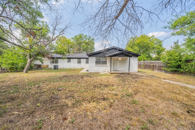 back of property featuring a yard