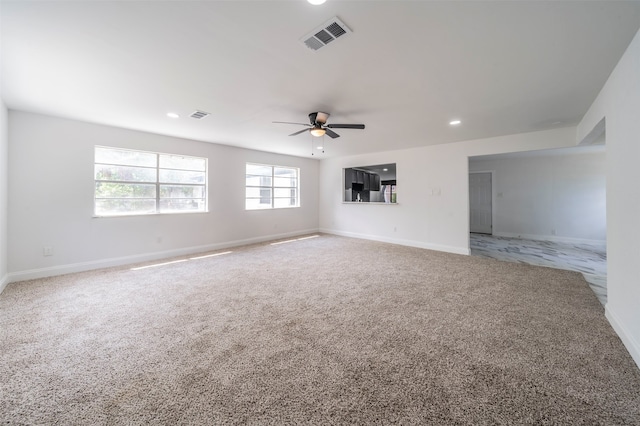 unfurnished room featuring light colored carpet and ceiling fan