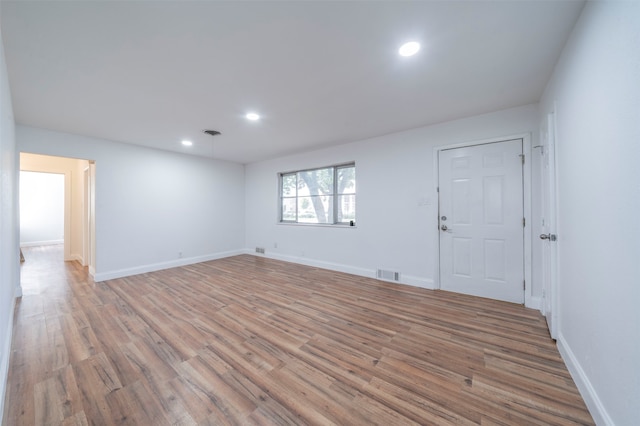 unfurnished room featuring hardwood / wood-style flooring