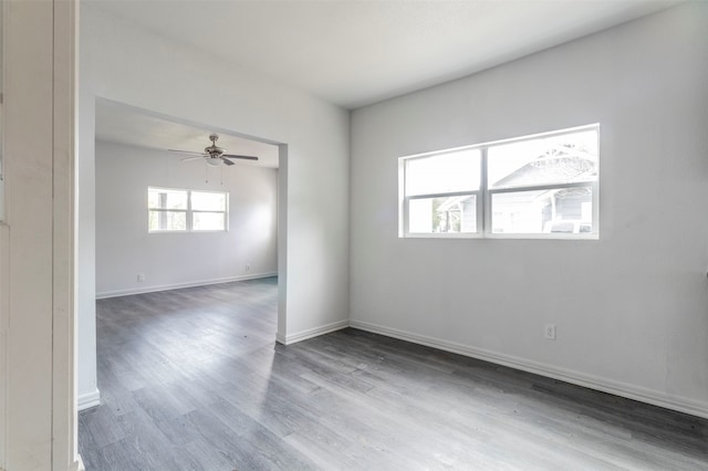 empty room with plenty of natural light and hardwood / wood-style floors