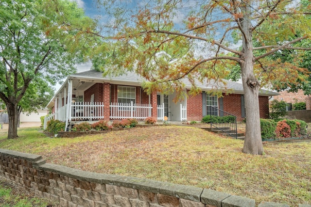 ranch-style home with a porch and a front lawn