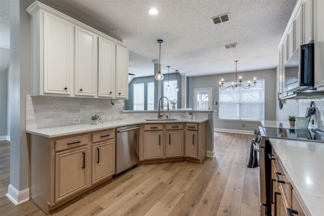 kitchen with sink, stainless steel appliances, plenty of natural light, and light hardwood / wood-style floors