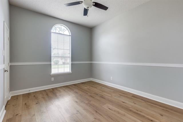 spare room featuring ceiling fan, light hardwood / wood-style floors, and a textured ceiling