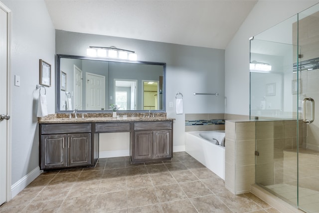 bathroom with tile patterned floors, vanity, plus walk in shower, and vaulted ceiling