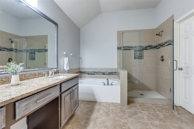 bathroom with tile patterned flooring, vanity, vaulted ceiling, and shower with separate bathtub