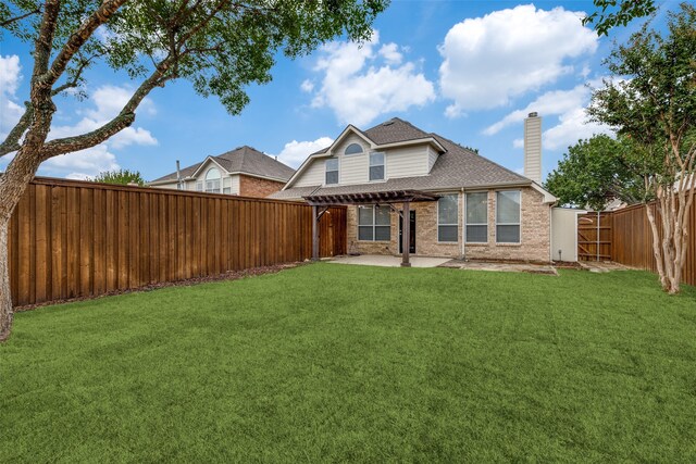 rear view of house featuring a pergola, a lawn, and a patio