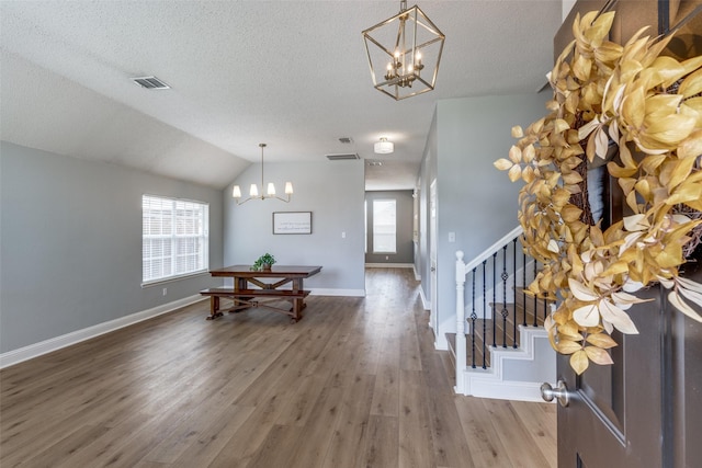 entryway featuring hardwood / wood-style flooring, plenty of natural light, and vaulted ceiling