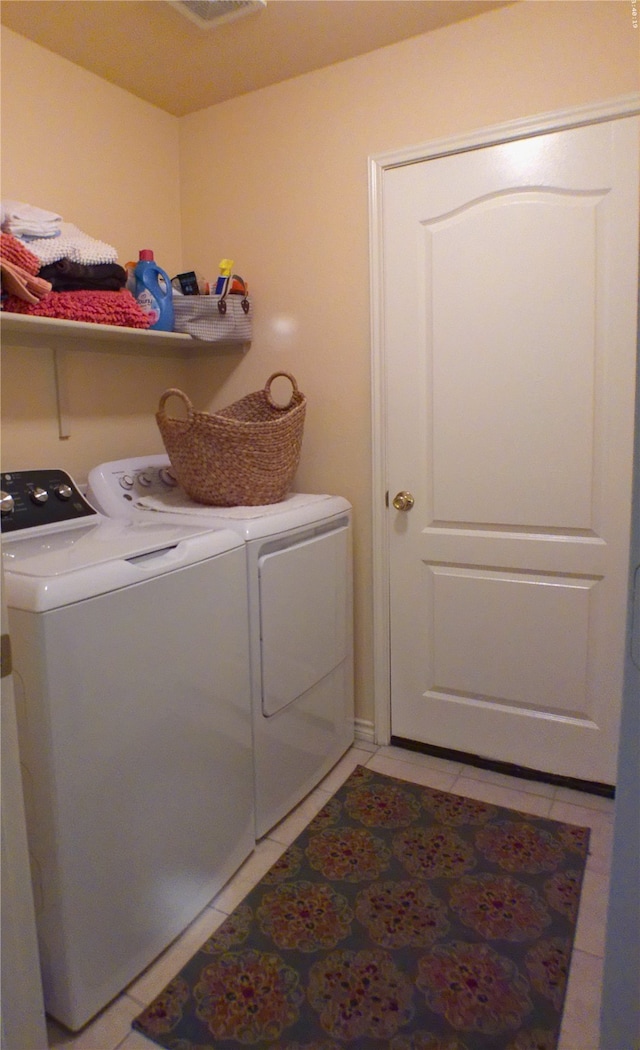 laundry area featuring light tile patterned floors and independent washer and dryer