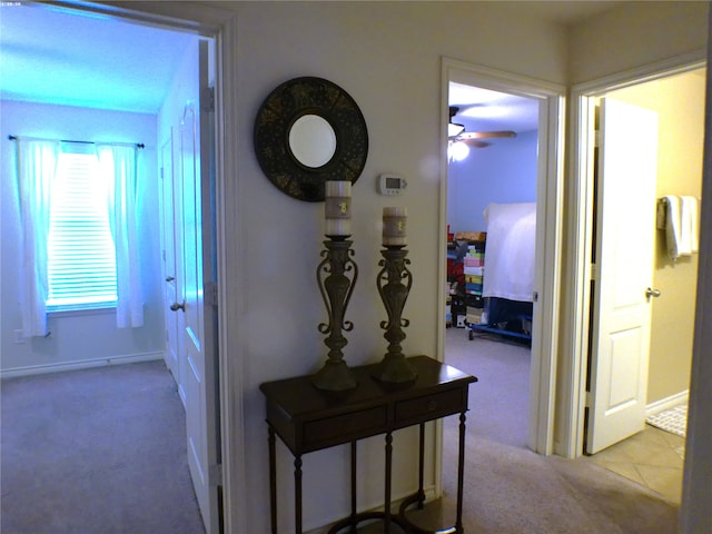 corridor featuring light colored carpet