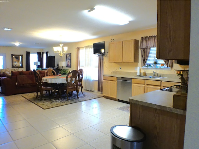 kitchen featuring light brown cabinetry, a notable chandelier, sink, light tile patterned flooring, and stainless steel dishwasher