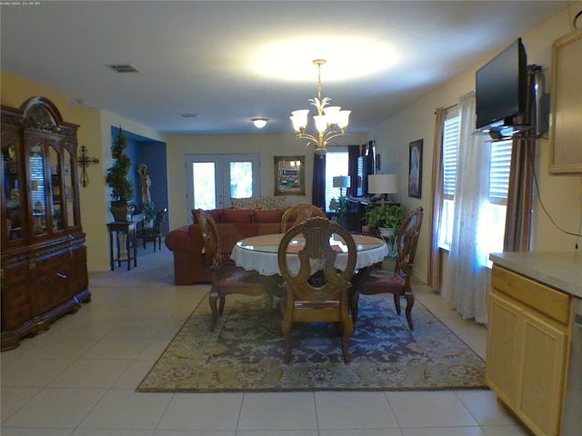 dining room featuring light tile patterned floors, a chandelier, and french doors