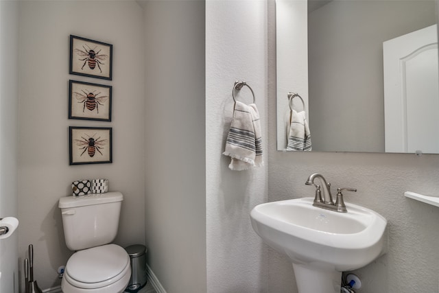 bathroom featuring toilet and sink