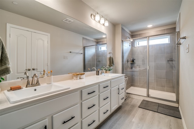 bathroom featuring vanity, wood-type flooring, and an enclosed shower