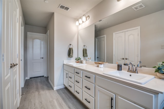 bathroom featuring vanity and hardwood / wood-style floors