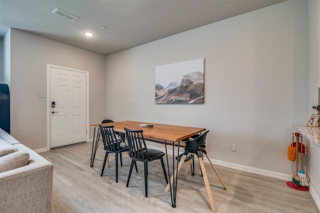 dining space with light hardwood / wood-style flooring