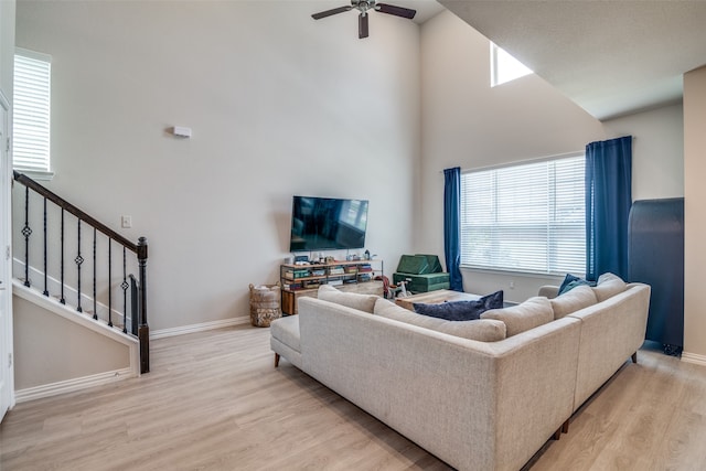 living room featuring plenty of natural light, ceiling fan, and light hardwood / wood-style floors