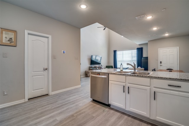 kitchen with dishwasher, light hardwood / wood-style flooring, sink, white cabinetry, and light stone counters