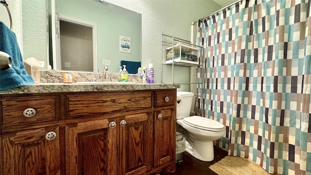 bathroom featuring toilet and vanity