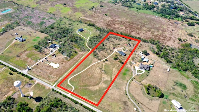 birds eye view of property with a rural view