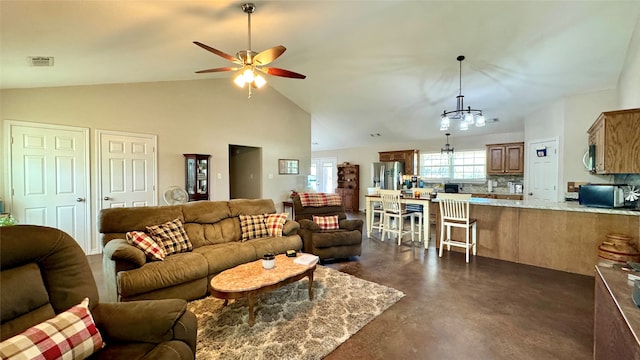 living room featuring ceiling fan with notable chandelier and high vaulted ceiling