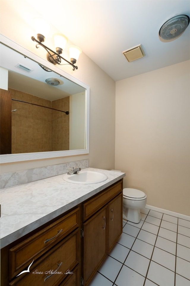 bathroom featuring tile patterned floors, vanity, and toilet