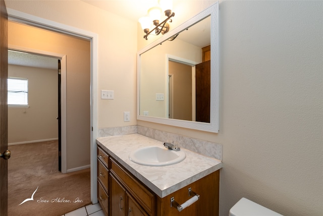 bathroom with tile patterned flooring, vanity, and toilet